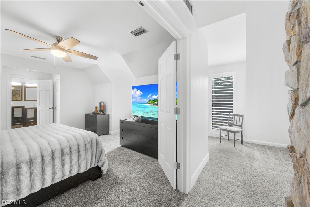 12991 Iona Road Fort Myers, FL 33908 - Photo 20 of 43 a bedroom with a bed and a chandelier