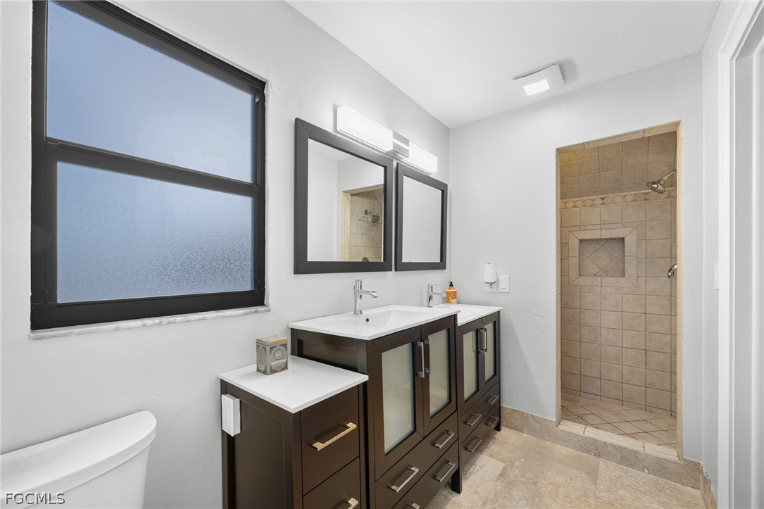 12991 Iona Road Fort Myers, FL 33908 - Photo 21 of 43 a bathroom with a toilet sink and mirror