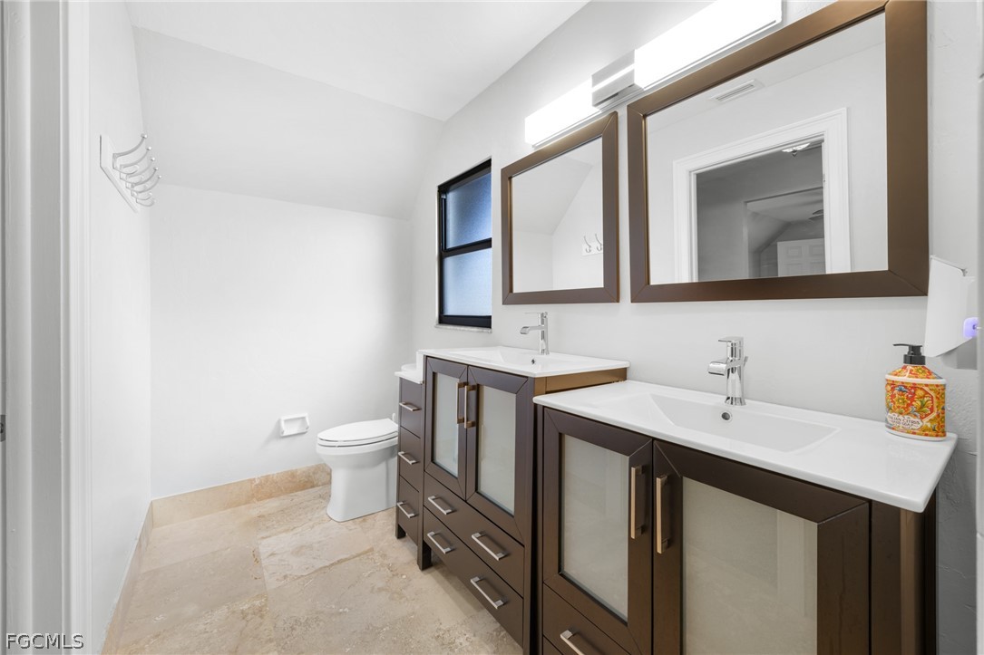 12991 Iona Road Fort Myers, FL 33908 - Photo 22 of 43 a bathroom with a toilet sink and mirror