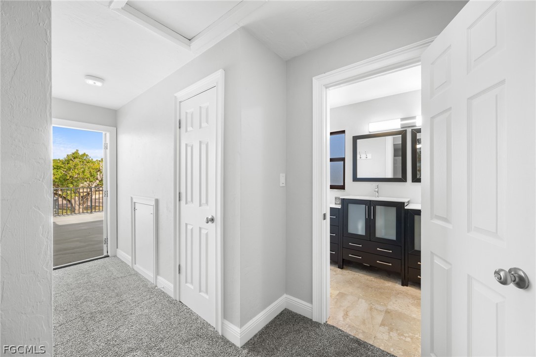 12991 Iona Road Fort Myers, FL 33908 - Photo 23 of 43 a view of a hallway and a livingroom with wooden floor