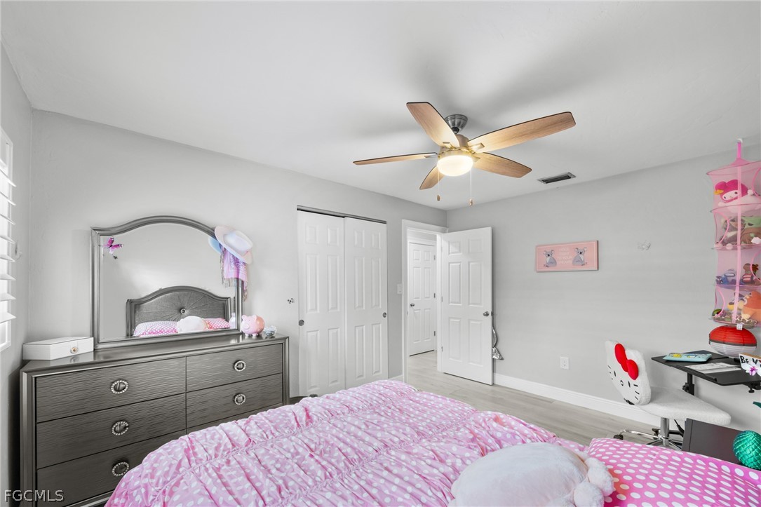 12991 Iona Road Fort Myers, FL 33908 - Photo 27 of 43 a bedroom with a bed and a dresser