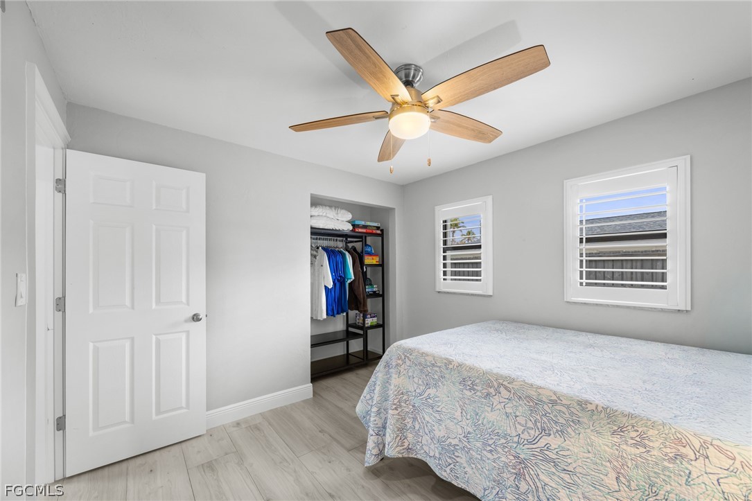 12991 Iona Road Fort Myers, FL 33908 - Photo 29 of 43 a bedroom with a bed and a chandelier