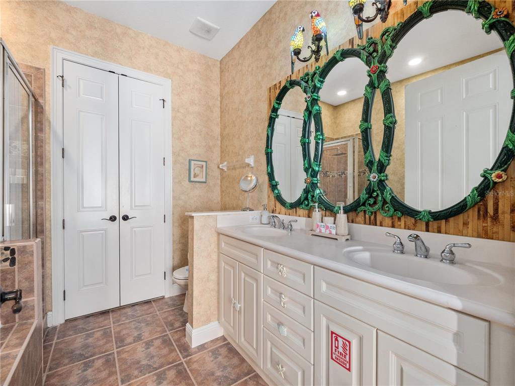 1424 Titian Court Reunion, FL 34747 - Photo 19 of 63 a en suite bathroom with double vanity sinks and a mirror