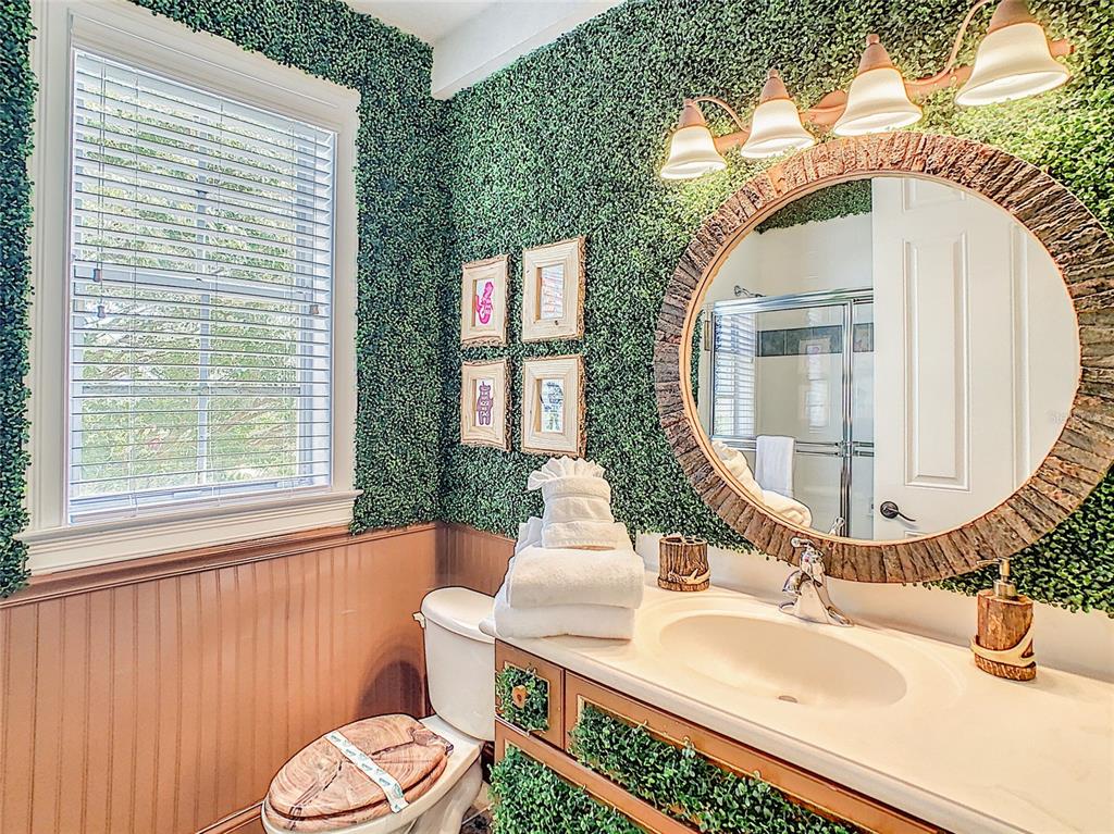 1424 Titian Court Reunion, FL 34747 - Photo 23 of 63 a bathroom with a sink mirror vanity and toilet