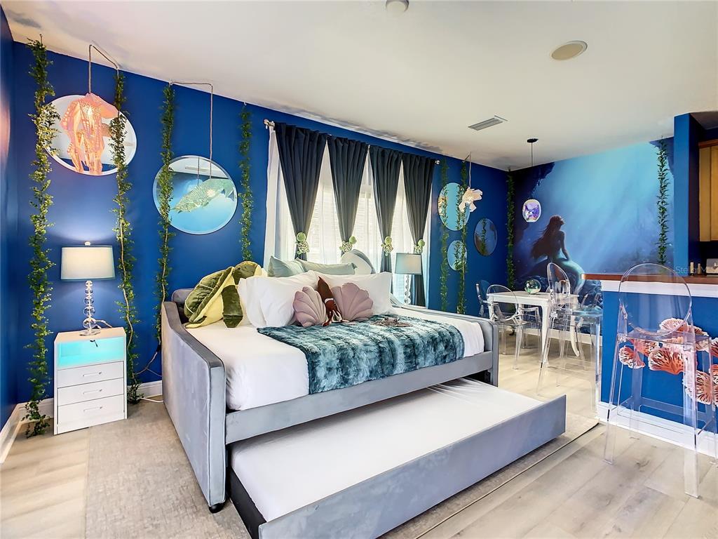 1424 Titian Court Reunion, FL 34747 - Photo 3 of 63 a bedroom with a bed and a lamp on dresser next to a window