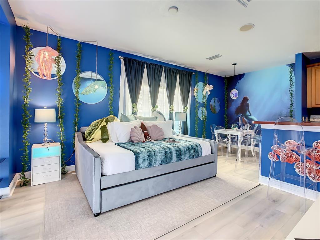 1424 Titian Court Reunion, FL 34747 - Photo 40 of 63 a bedroom with a bed and a chandelier