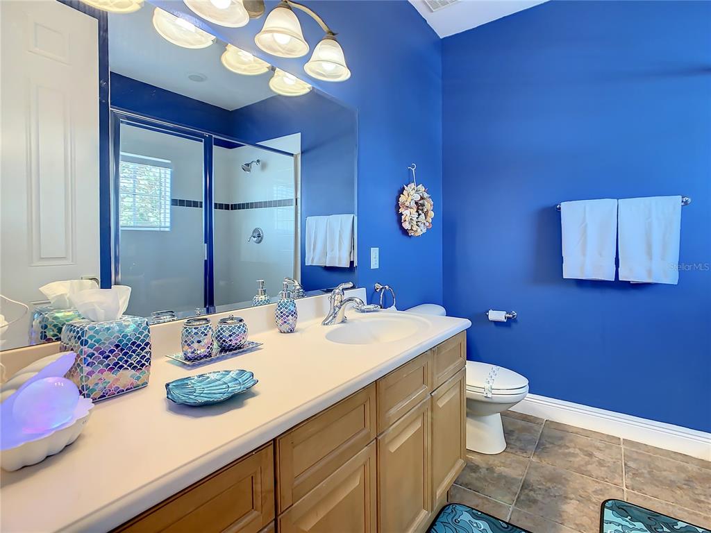 1424 Titian Court Reunion, FL 34747 - Photo 47 of 63 a bathroom with a sink a vanity and a mirror