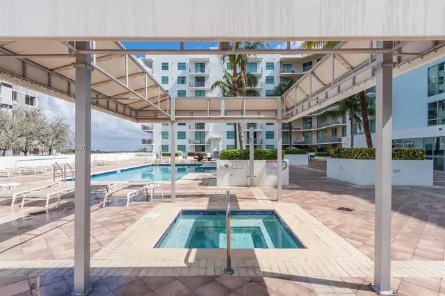 a living room with furniture a chandelier and a window