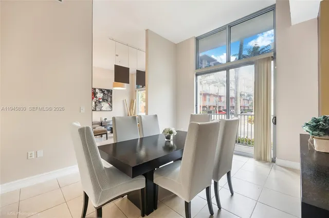 a view of a dining room with furniture a chandelier and wooden floor