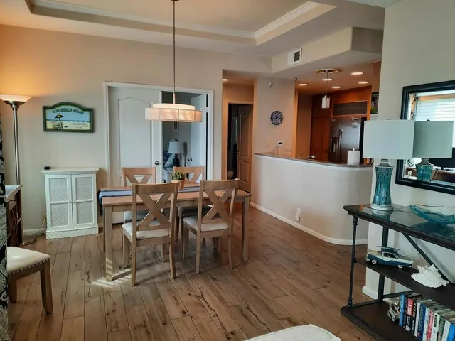 a view of a dining room with furniture and wooden floor
