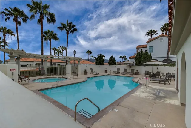 an outdoor space with swimming pool and furniture