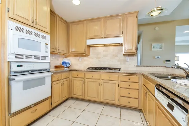 a kitchen with granite countertop cabinets stainless steel appliances a sink and a counter space