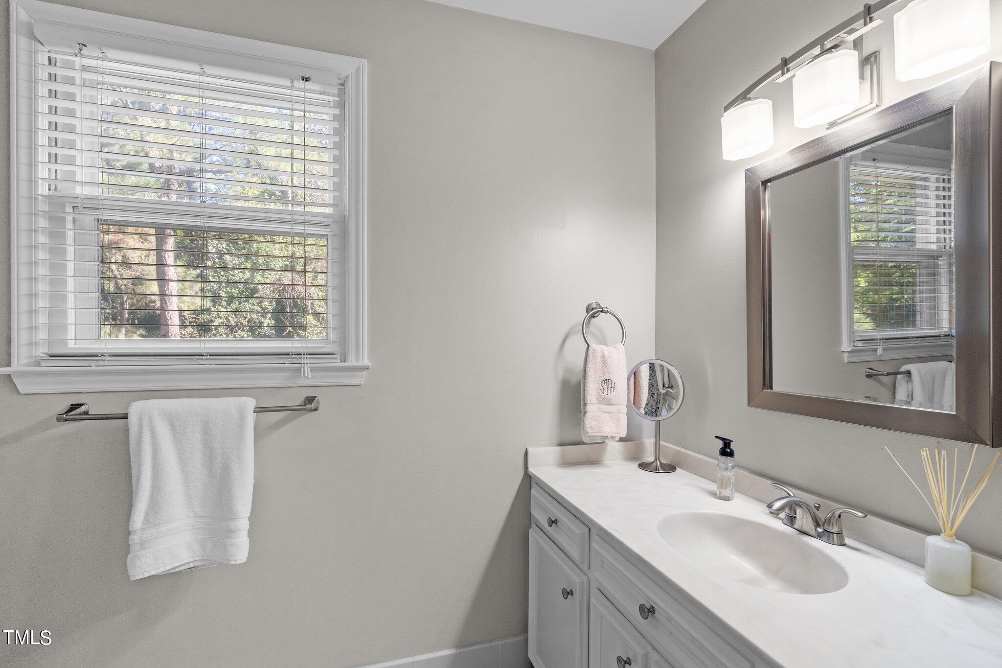 801 Purdue Street Raleigh, NC 27609 - Photo 20 of 40 a bathroom with a sink vanity and a mirror
