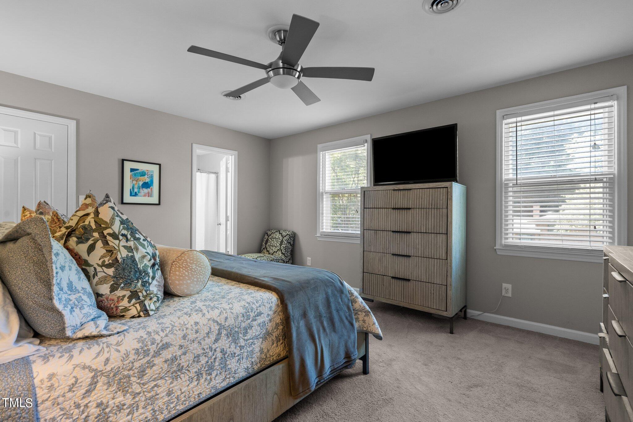 801 Purdue Street Raleigh, NC 27609 - Photo 27 of 40 a bedroom with a bed and a flat screen tv