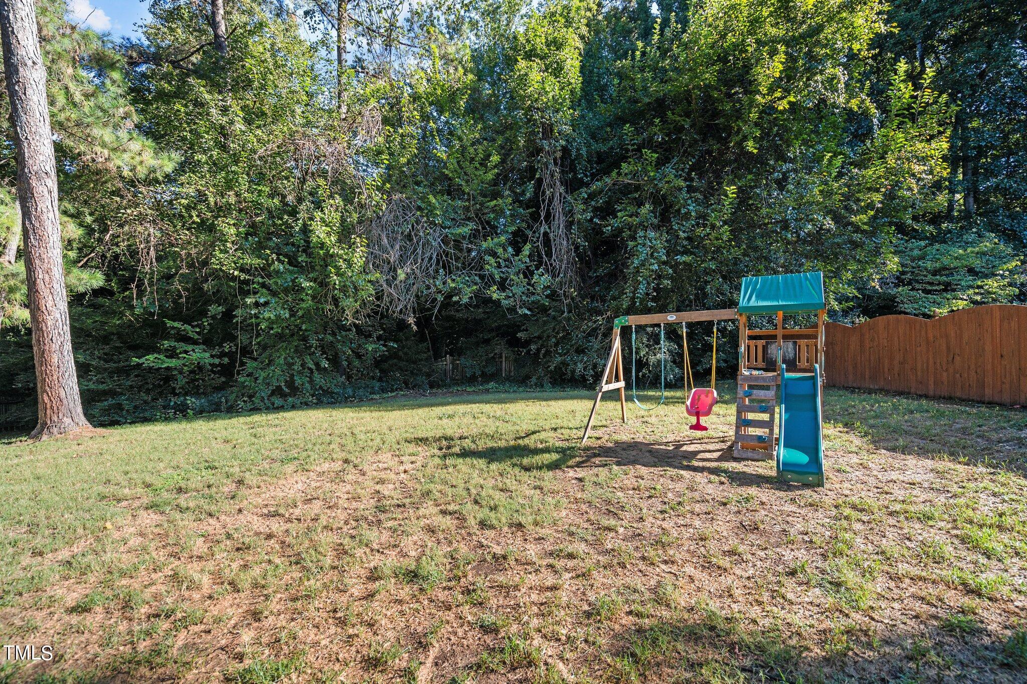 801 Purdue Street Raleigh, NC 27609 - Photo 35 of 40 a view of outdoor space with playground and green space