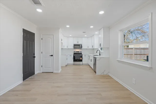 a kitchen with appliances cabinets and a sink