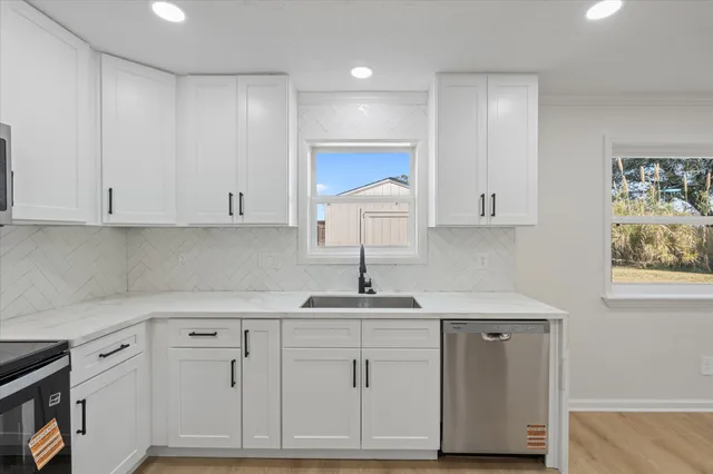 an empty room with ceiling fan and window