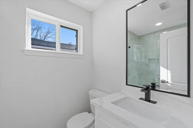 a view of a backyard with large trees and wooden fence