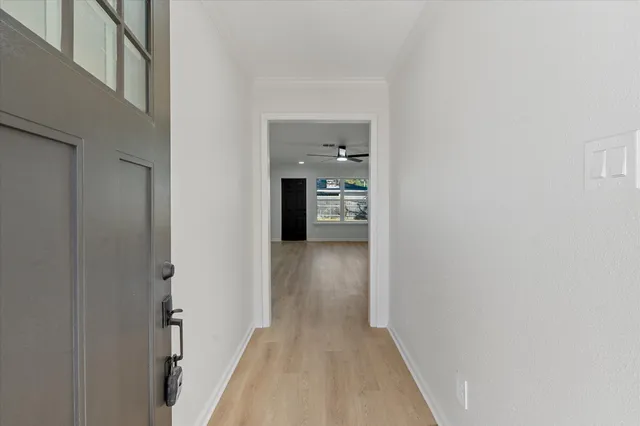 a view of a hallway with wooden shelves