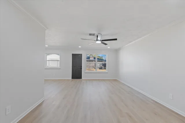 wooden floor in an empty room with a window