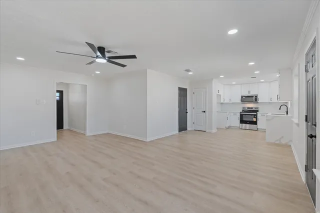 a view of an empty room with a ceiling fan
