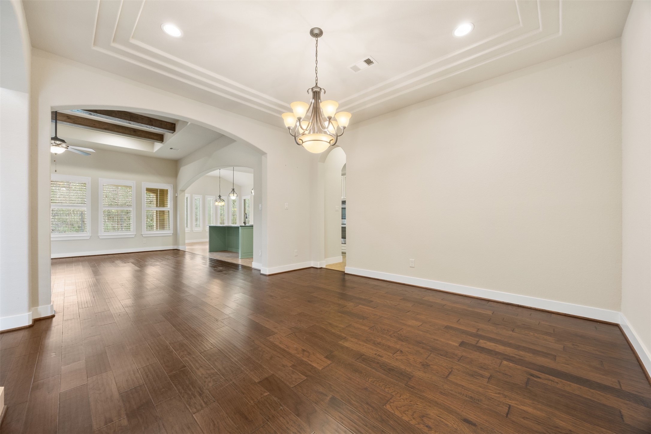 6515 Fraser Point Spring, TX 77379 - Photo 5 of 39 a view of an empty room with wooden floor and a kitchen