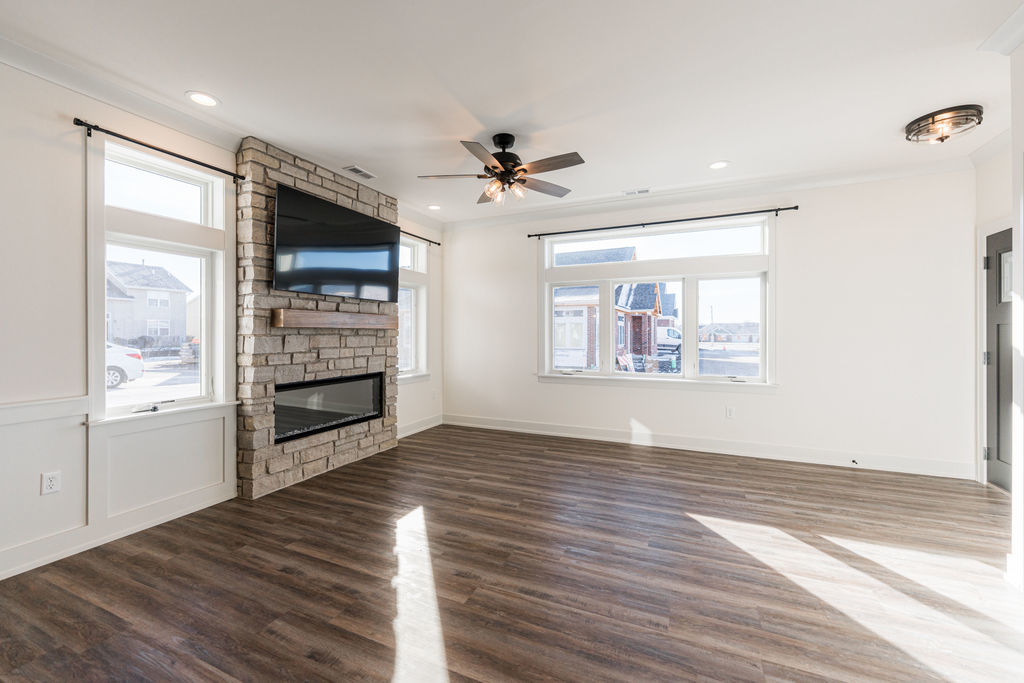 46 Kloe Lane, Unit 46 Sycamore, IL 60178 - Photo 4 of 54 wooden floor in an empty room with a window and a kitchen