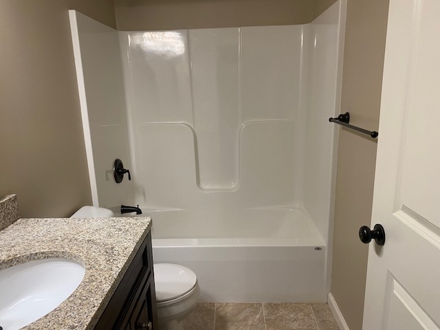 2225 7th Street Peru, IL 61354 - Photo 8 of 15 a bathroom with a granite countertop sink toilet and shower