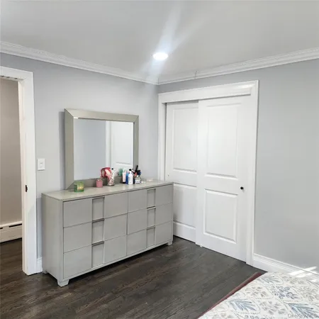 a room with mirror and a wooden floor