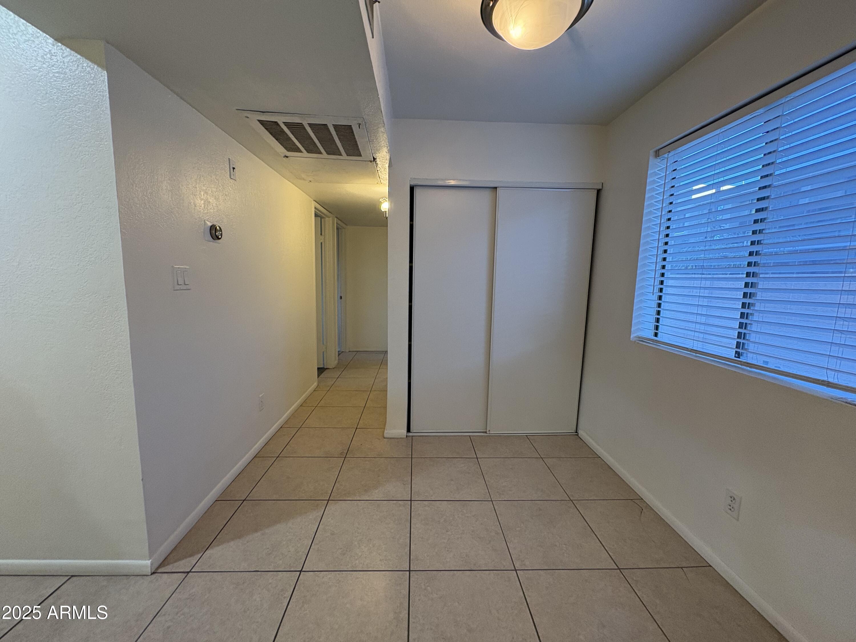 2938 North 61st Place, Unit 150 Scottsdale, AZ 85251 - Photo 12 of 24 a view of an empty room with a window