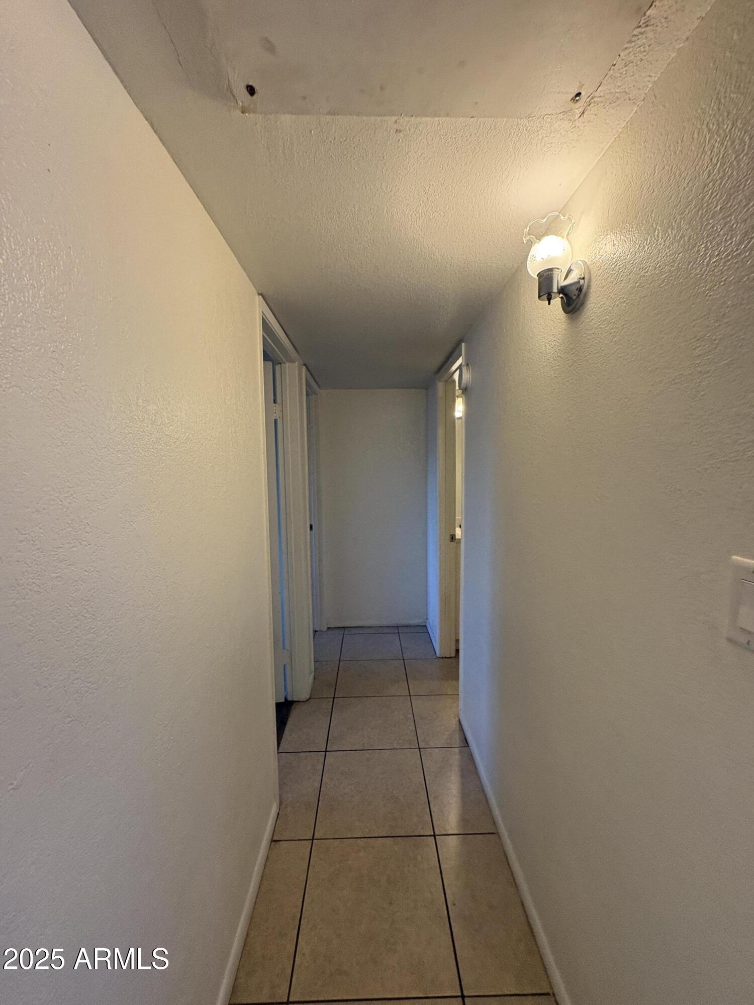 2938 North 61st Place, Unit 150 Scottsdale, AZ 85251 - Photo 14 of 24 a view of hallway with a window and a mirror