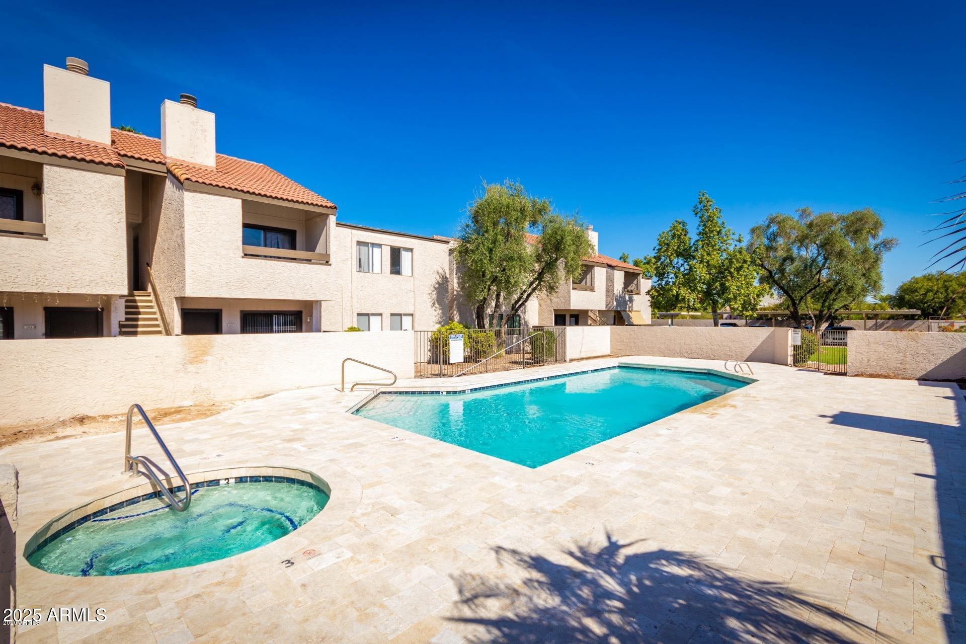 2938 North 61st Place, Unit 150 Scottsdale, AZ 85251 - Photo 21 of 24 a swimming pool with outdoor seating and yard