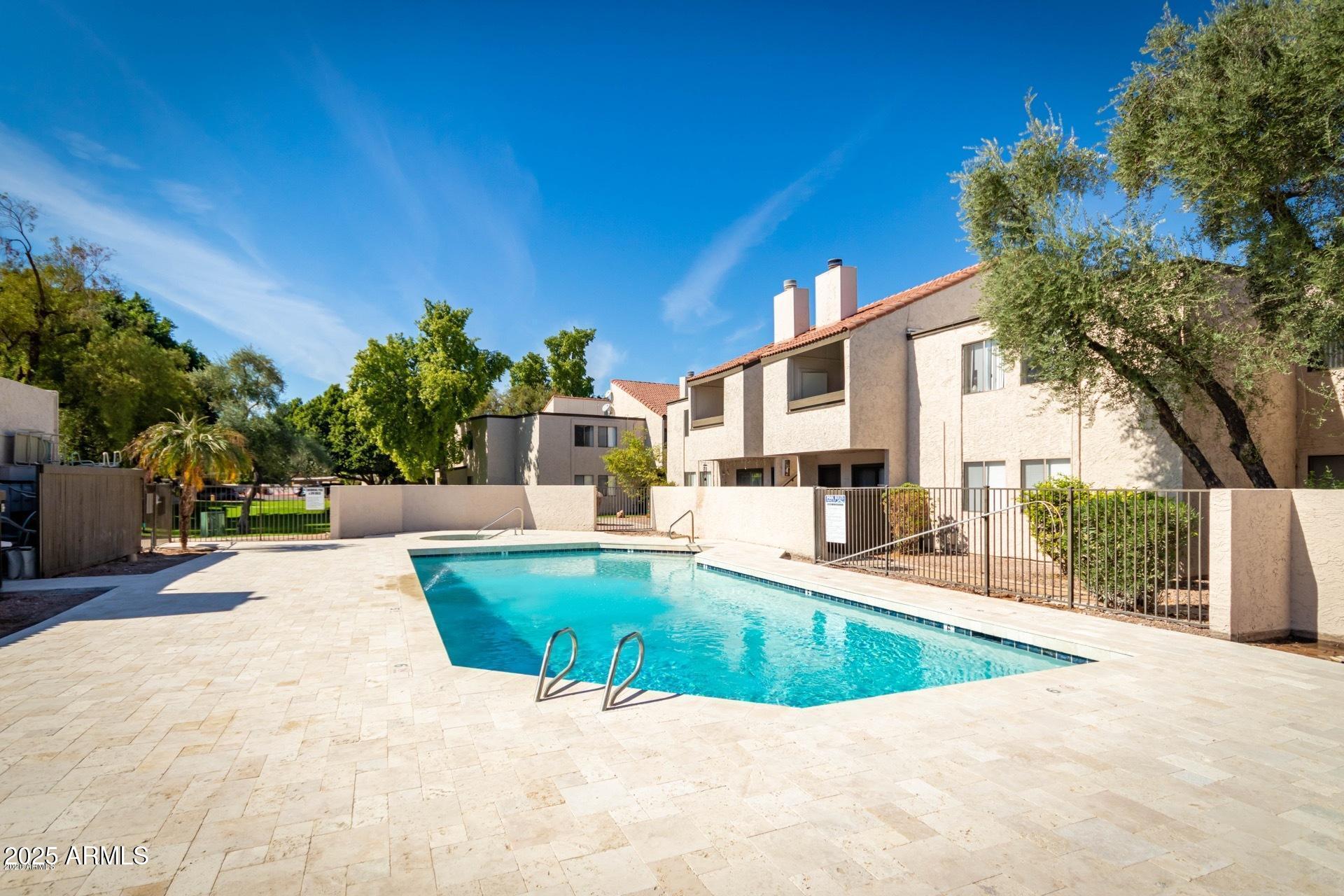 2938 North 61st Place, Unit 150 Scottsdale, AZ 85251 - Photo 22 of 24 a view of a swimming pool with a patio