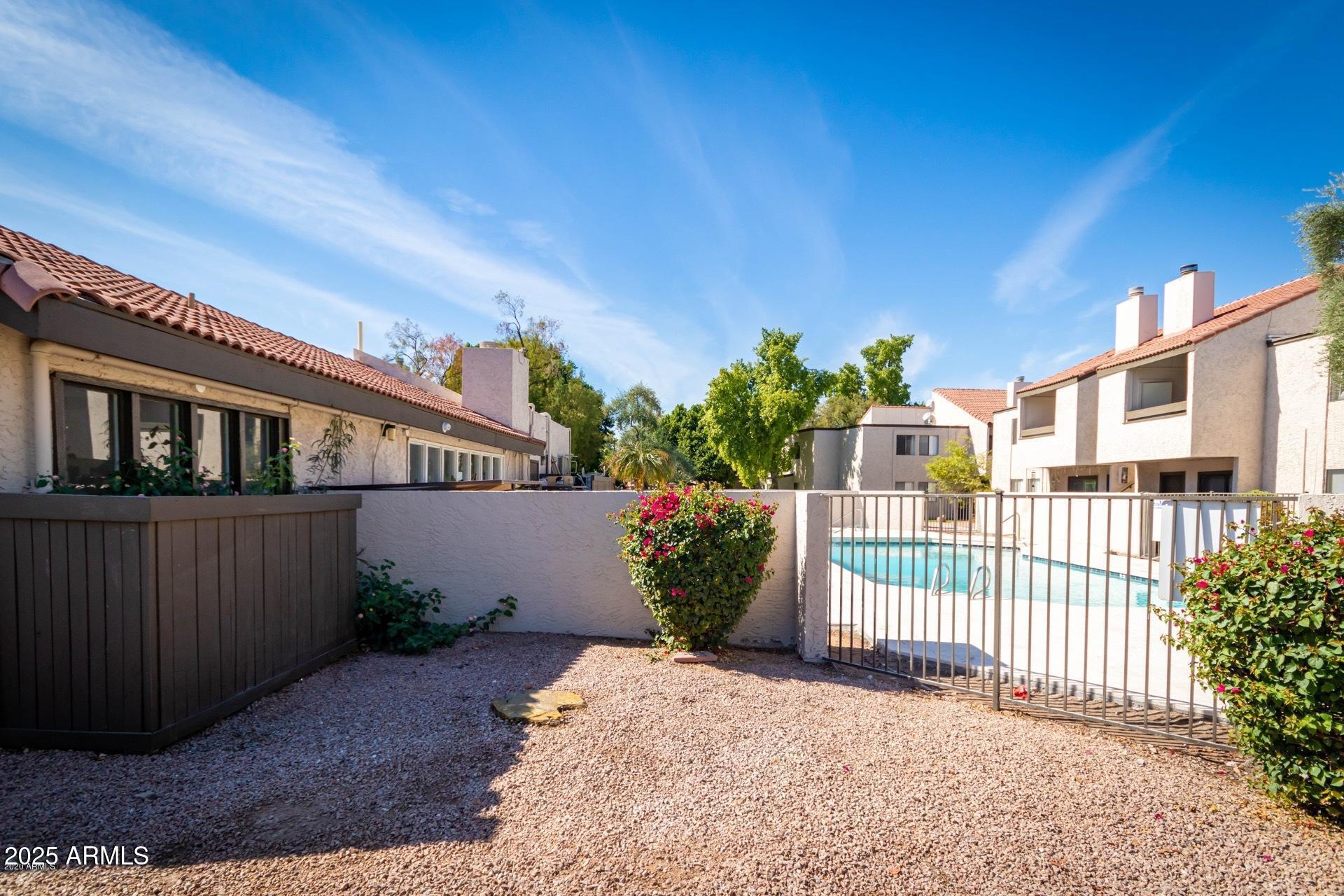 2938 North 61st Place, Unit 150 Scottsdale, AZ 85251 - Photo 23 of 24 a view of a house with wooden fence