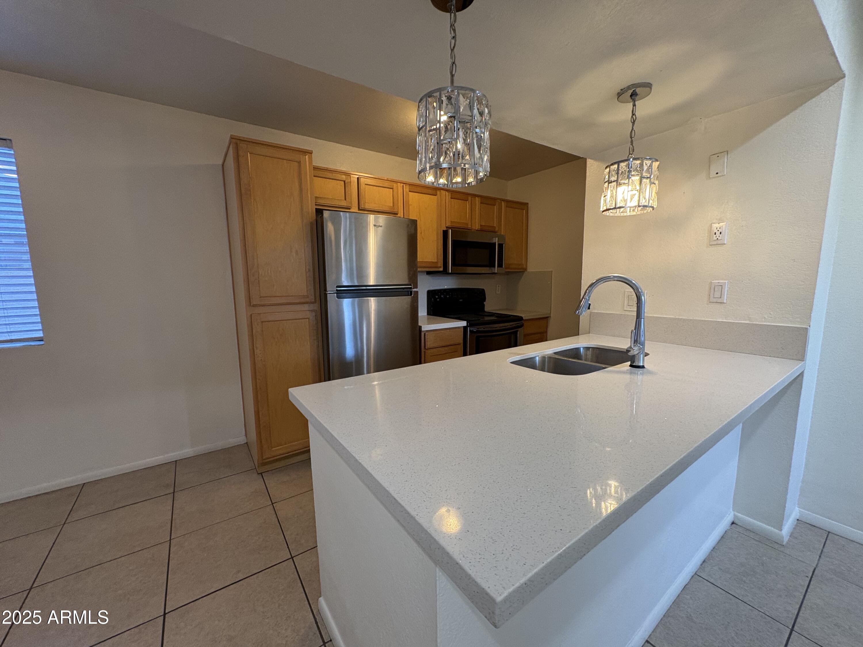 2938 North 61st Place, Unit 150 Scottsdale, AZ 85251 - Photo 8 of 24 a kitchen with stainless steel appliances a refrigerator sink and microwave