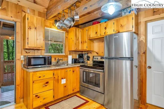 a kitchen with stainless steel appliances a refrigerator sink and cabinets