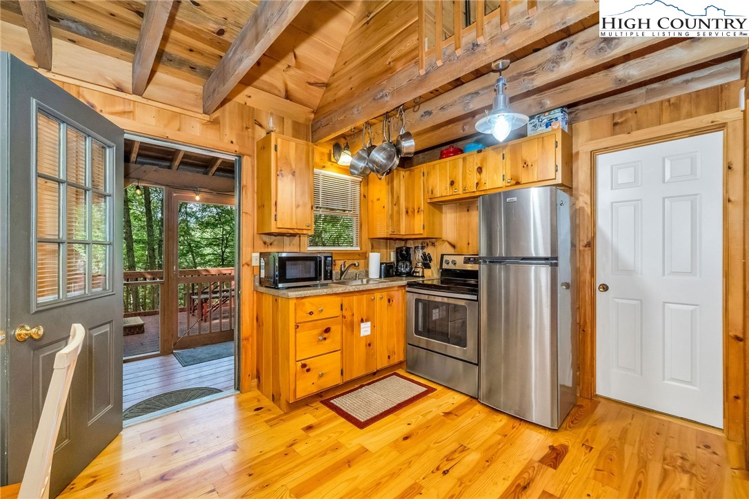 199 Skyline Road West Jefferson, NC 28694 - Photo 12 of 35 a kitchen with stainless steel appliances granite countertop a refrigerator and a stove