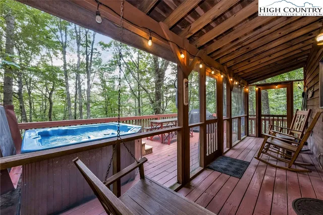 a view of a balcony with wooden floor and outdoor seating