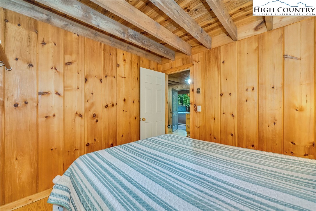199 Skyline Road West Jefferson, NC 28694 - Photo 21 of 35 a bedroom with a bed and a mirror