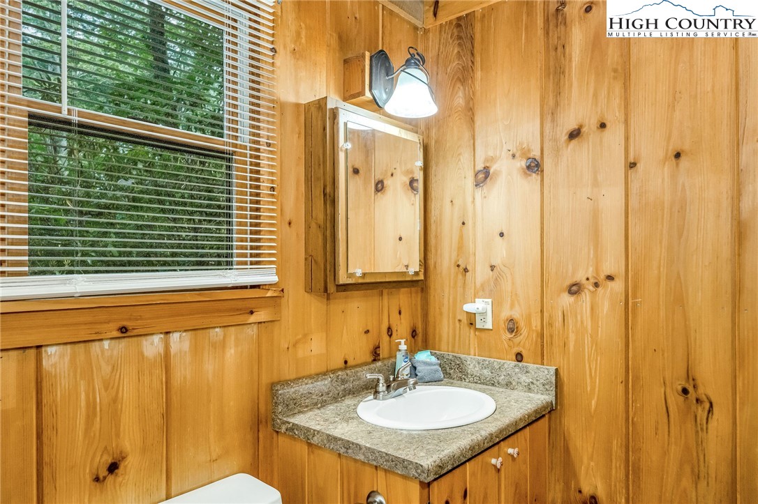 199 Skyline Road West Jefferson, NC 28694 - Photo 23 of 35 a bathroom with a sink and a mirror