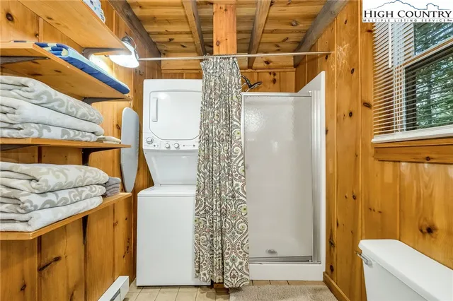 a bathroom with a toilet and shower curtain