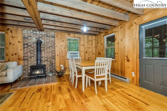 a dining room with wooden floor and furniture