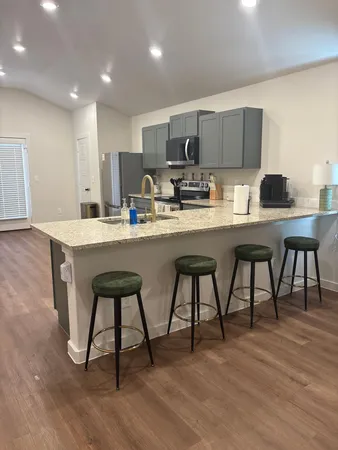 a kitchen with appliances cabinets and wooden floor