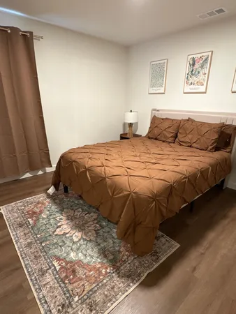 a bedroom with a bed and a window