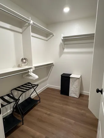 a view of a room with wooden floor and staircase