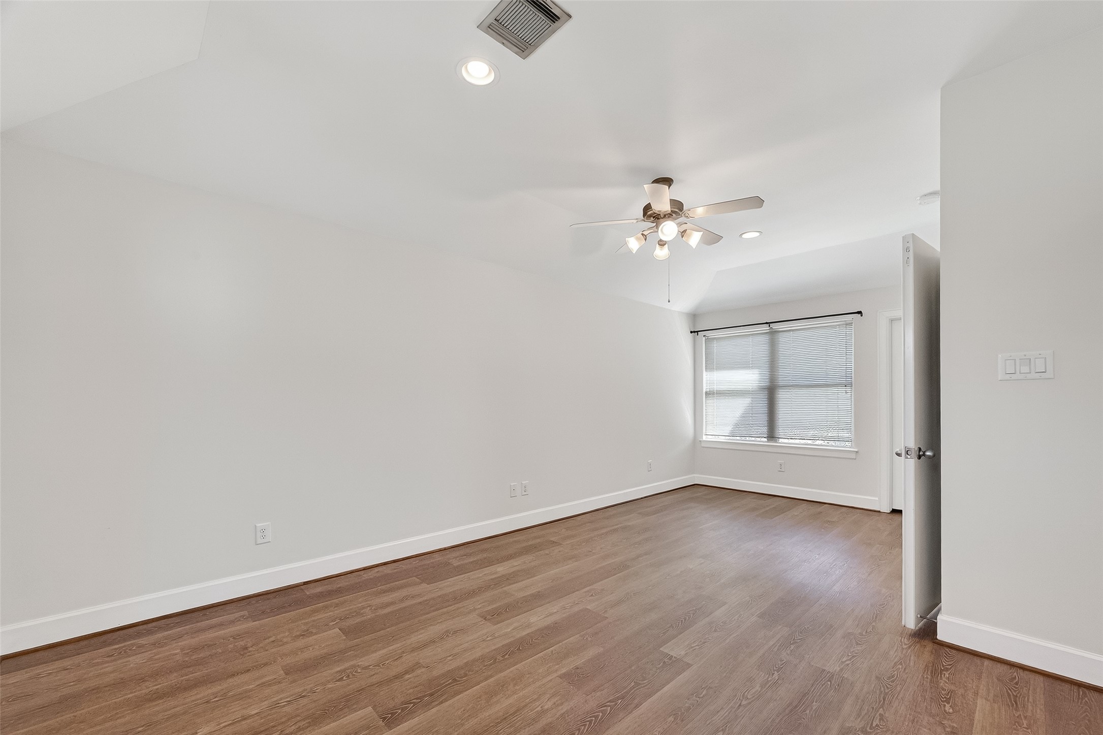 5951 S Loop East, Unit 47 Houston, TX 77033 - Photo 18 of 37 Primary Bedroom is a bright and spacious room with wood flooring, neutral walls, and a large window providing natural light.