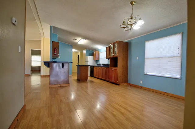 a view of a livingroom with furniture wooden floor and a window