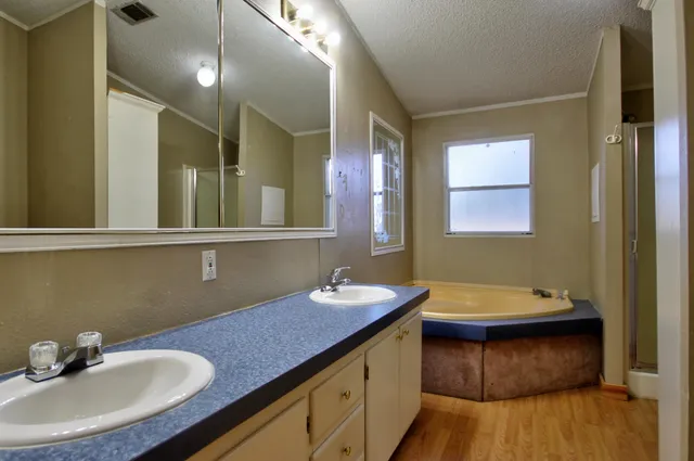 a bathroom with a sink double vanity and a mirror