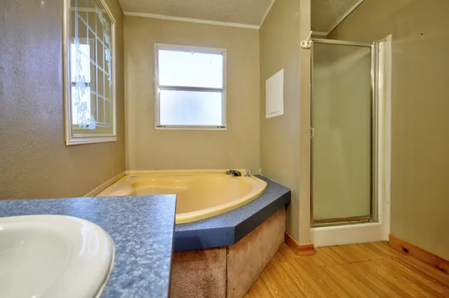 a spacious bathroom with a tub and shower