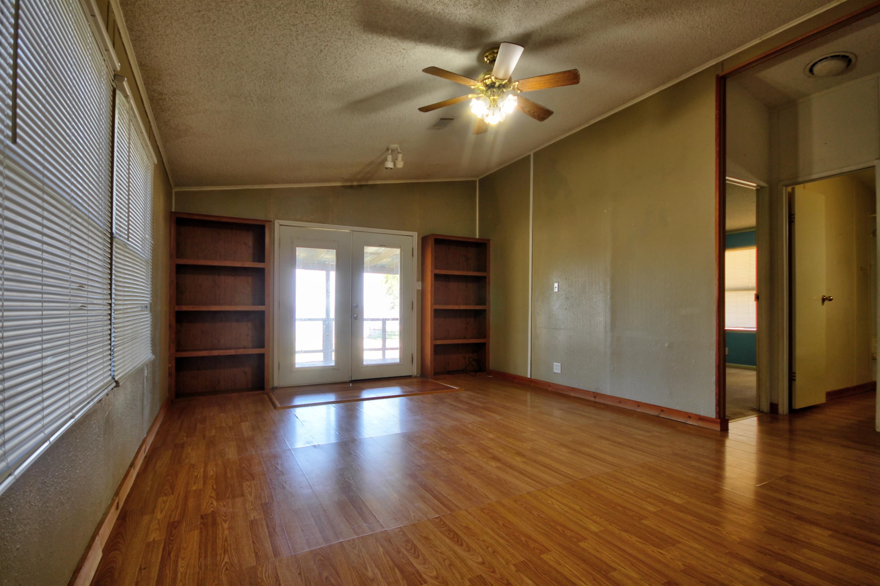 1504-2 Ranch Road 261 Buchanan Dam, TX 78609 - Photo 8 of 22 wooden floor in an empty room with a window